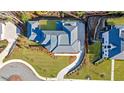 An aerial view shows the manicured lawn, curved driveway, and complex roofline of this estate at 835 Kenry Ct, Atlanta, GA 30342