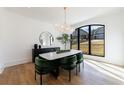 Bright dining room featuring modern lighting fixture, large window, and stylish decor at 835 Kenry Ct, Atlanta, GA 30342