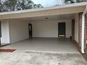 Spacious carport with concrete flooring and two convenient entry doors to the house at 213 Sharon Drive, Canton, GA 30115