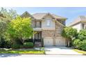 Charming two-story brick home with a two-car garage and manicured landscaping at 4022 Newhaven Ne Cir, Brookhaven, GA 30319