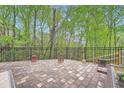 A spacious brick patio with an iron fence, perfect for outdoor entertaining and enjoying the wooded view at 317 Water Oak Ln, Canton, GA 30114