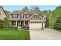 Beautiful two-story home featuring a two car garage, stone accents, and manicured lawn at 317 Water Oak Ln, Canton, GA 30114