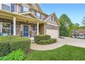 Beautiful two-story home featuring a two car garage, stone accents, and manicured lawn at 317 Water Oak Ln, Canton, GA 30114
