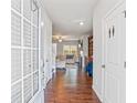 Bright entryway features hardwood floors, an open view of the living room, and a coat closet at 3200 Baylor Cir, Mcdonough, GA 30253