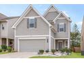Charming home showcasing a well-manicured lawn, gray siding, and attached two-car garage at 3200 Baylor Cir, Mcdonough, GA 30253