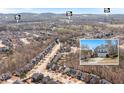 A neighborhood aerial view shows nearby community homes and location at 4225 Hopewell Manor Dr, Cumming, GA 30028