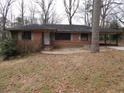 Charming single-story brick home featuring an open carport and front yard at 4269 Mercer Rd, Decatur, GA 30035