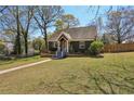 Inviting home exterior with lush green lawn and mature trees on a sunny day at 2621 White Oak Dr, Decatur, GA 30032