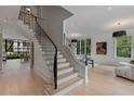 Bright foyer featuring hardwood floors, a staircase with iron railings, and large windows at 96 The Prado Ne, Atlanta, GA 30309