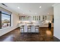 Spacious and sunny white kitchen featuring a large island and hardwood floors at 3286 Northside Nw Pkwy # 1007, Atlanta, GA 30327