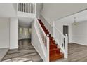Elegant staircase with wood steps and white railing, leading to the upper level at 3635 Spring Mesa Dr, Snellville, GA 30039