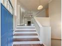 Inviting foyer with hardwood stairs leading to a spacious living area, seen from the front door at 6490 Lake Esther Dr, Fairburn, GA 30213