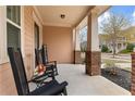Inviting front porch with rocking chairs, creating a relaxing outdoor space at 155 Concord Ct, Fayetteville, GA 30214