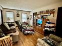 Cozy living room with hardwood floors, tv, recliner, and natural light at 6917 Laurelwood Dr, Douglasville, GA 30135