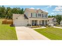 Inviting two-story home with a spacious driveway and manicured front yard at 1661 Flagstone Ln, Conyers, GA 30012