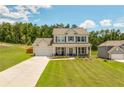 Beautiful two-story home featuring a well-kept lawn, attached garage, and covered porch at 1661 Flagstone Ln, Conyers, GA 30012