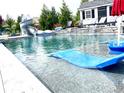 Resort-style pool with a slide, sun loungers, and lush greenery, perfect for relaxation and entertainment at 526 Rosemont Ave, Canton, GA 30115