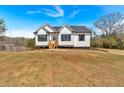 Beautiful home featuring a well-maintained lawn and classic architectural details at 81 Bridgemill Dr, Douglasville, GA 30134