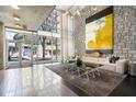 Contemporary lobby with tall ceilings, modern art, large windows, and comfortable seating arrangement at 845 Spring St # 125, Atlanta, GA 30308