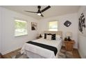 Well-lit bedroom with neutral tones, two windows and a modern ceiling fan at 1048 Pinehurst Se Dr, Smyrna, GA 30080