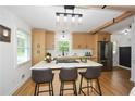Well-lit kitchen features stainless steel appliances, a large island with bar seating, and natural wood cabinetry at 1048 Pinehurst Se Dr, Smyrna, GA 30080