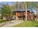Two-story house with a stone base, wood siding, and a second-story balcony at 3100 Meadow Dr, Marietta, GA 30062