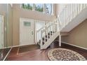 Light-filled foyer with high ceilings, wood floors, and a modern staircase at 3100 Meadow Dr, Marietta, GA 30062