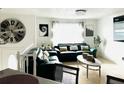 Bright living room with leather sofas, decorative pillows, and eye-catching wall decor, creating a cozy and inviting space at 6308 Boyett Drive Dr, Norcross, GA 30093