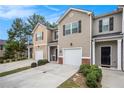 Charming townhouse row featuring attached garages, well-manicured landscaping and driveways at 1310 Roger Trace, Lithonia, GA 30058