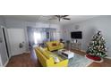 Bright living room featuring yellow couches and adjacent dining area with plenty of natural light at 1780 Brookside Lay Cir, Norcross, GA 30093