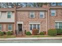 A brick townhome showcases trimmed bushes and a tidy front lawn at 3403 Ashwood Ln, Atlanta, GA 30341