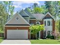 Charming two-story home with a brick facade, manicured lawn, and mature trees at 1725 Silverchase Sw Dr, Marietta, GA 30008
