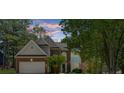 Charming two-story home with a brick facade, manicured lawn, and mature trees at 1725 Silverchase Sw Dr, Marietta, GA 30008