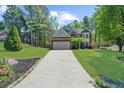 Charming two-story home with a brick facade, manicured lawn, and long driveway at 1725 Silverchase Sw Dr, Marietta, GA 30008