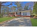 Beautiful ranch-style home with a brick facade, complemented by a long driveway at 272 Colchester Dr, Stone Mountain, GA 30088