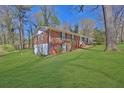 Lovely brick home with a sprawling green lawn, surrounded by mature trees at 272 Colchester Dr, Stone Mountain, GA 30088