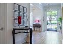 Elegant foyer with hardwood floors, a stylish console table, and a bright view through the front door at 515 Danube Ne Rd, Atlanta, GA 30342