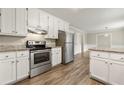 Well-equipped kitchen featuring granite countertops, stainless steel appliances, and updated cabinets at 2802 Oak Meadow Ln, Snellville, GA 30078