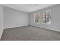 Bright bedroom with neutral carpet, gray walls, white trim, and two windows providing ample natural light at 5219 Sweet Air Ln, Stone Mountain, GA 30088
