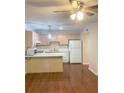 Traditional kitchen featuring white appliances, light cabinets, and an eat-in peninsula at 919 Dunbar Dr, Dunwoody, GA 30338