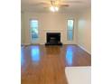 Bright living room with hardwood floors, fireplace, and a door leading to outdoor space at 919 Dunbar Dr, Dunwoody, GA 30338