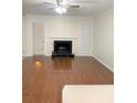 Bright living room with hardwood floors, fireplace, and a door leading to outdoor space at 919 Dunbar Dr, Dunwoody, GA 30338