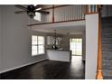 Bright living room flowing into a modern kitchen with granite countertops and dark hardwood floors at 253 Woodland Way, Canton, GA 30114