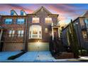 Inviting two-story brick townhouse with a front-facing garage and charming architectural details at 2766 Birch Grove Se Ln # 11, Marietta, GA 30067