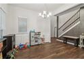 Bright sitting room with wood floors, classic wainscoting, and a stylish chandelier at 4443 Quilter St, Powder Springs, GA 30127