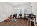 Spacious sitting room filled with toys, featuring hardwood floors and ample natural light at 4443 Quilter St, Powder Springs, GA 30127