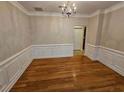 Dining room with hardwood floors, decorative trim and chandelier at 100 Iverson Pl, Temple, GA 30179