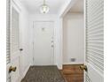Bright entryway with tiled floor, white walls, and a stylish light fixture at 1933 Silvastone Dr, Decatur, GA 30033