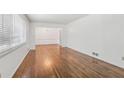 Spacious living room with hardwood floors and a view into the dining area at 1933 Silvastone Dr, Decatur, GA 30033