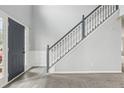 Inviting foyer showcasing a staircase with white railings and a dark blue accent door at 2529 Brookgate Way, Ellenwood, GA 30294